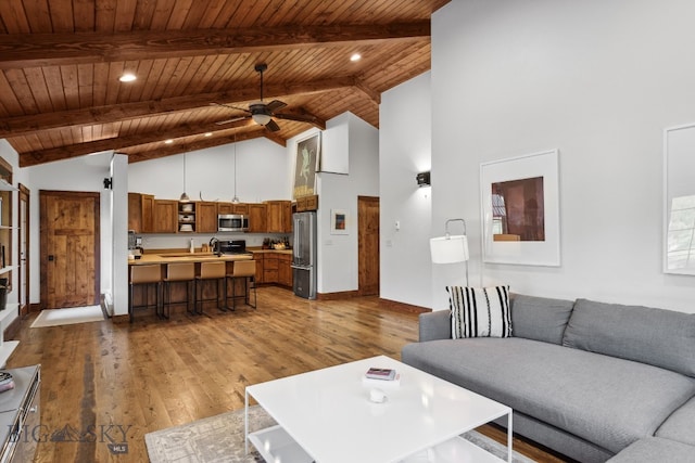 living room with dark hardwood / wood-style floors, high vaulted ceiling, ceiling fan, and wood ceiling