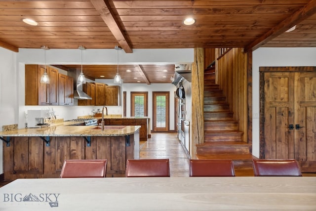 kitchen featuring beam ceiling, sink, wooden ceiling, hanging light fixtures, and kitchen peninsula