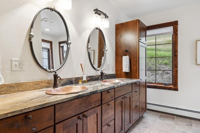 bathroom with vanity and a baseboard heating unit