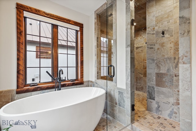 bathroom with separate shower and tub and tile walls