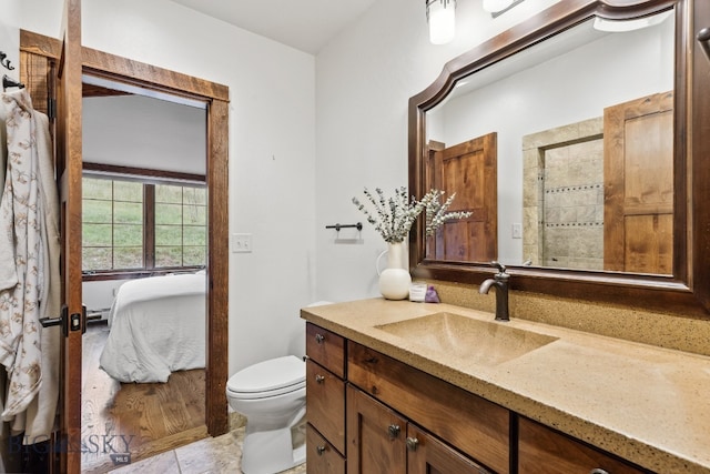 bathroom featuring tile patterned floors, vanity, a baseboard heating unit, and toilet