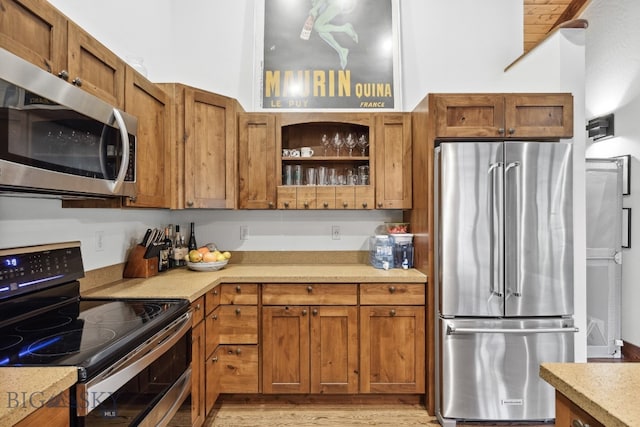 kitchen featuring stainless steel appliances and light hardwood / wood-style floors