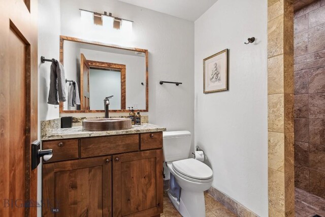 bathroom featuring tile patterned floors, vanity, and toilet