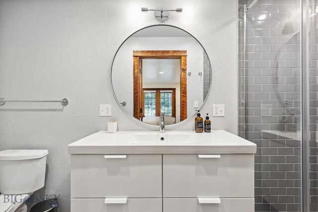 bathroom with vanity, toilet, and walk in shower