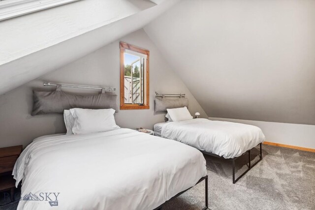 bedroom with light carpet and vaulted ceiling