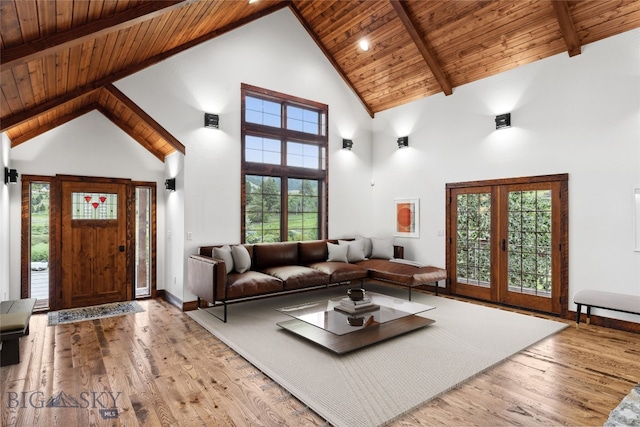 living room with high vaulted ceiling, french doors, light wood-type flooring, beam ceiling, and wood ceiling