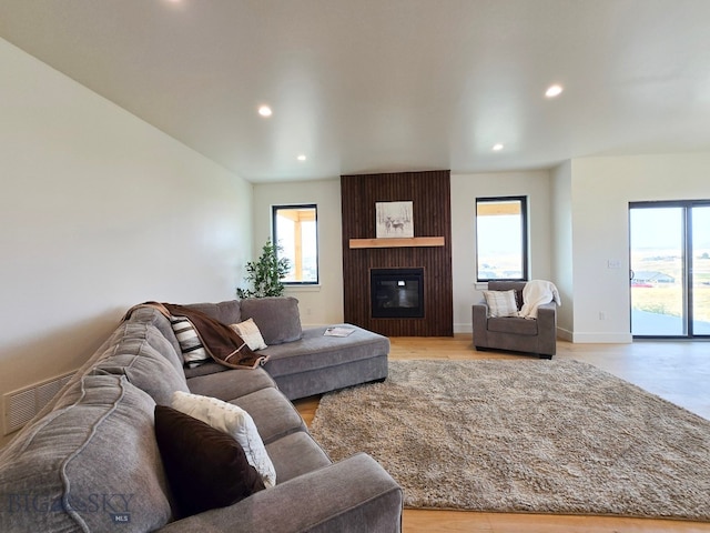 living room with plenty of natural light and a large fireplace