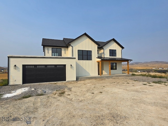 modern inspired farmhouse featuring a mountain view and a garage