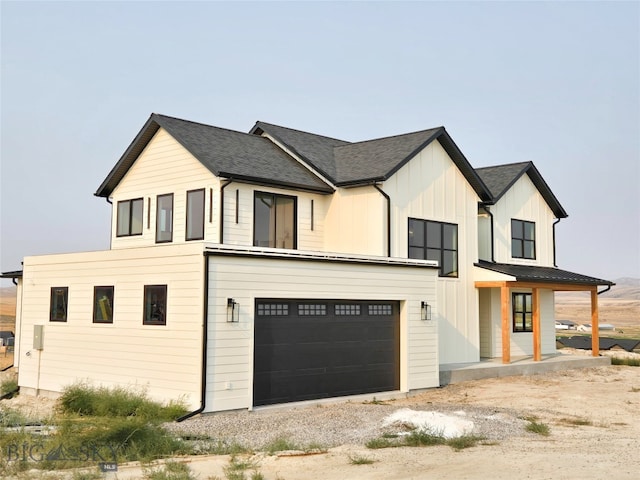 modern inspired farmhouse with a garage