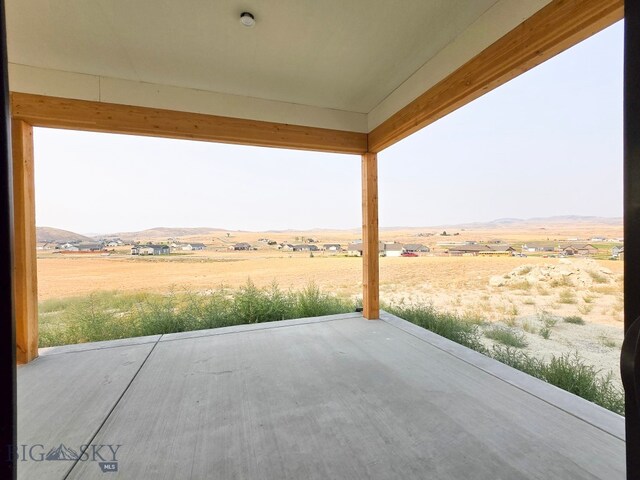 view of patio / terrace featuring a rural view and a mountain view