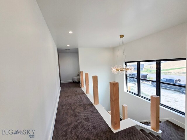 corridor featuring dark colored carpet