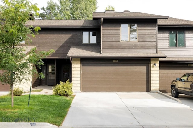 view of front of house featuring a garage and a front lawn