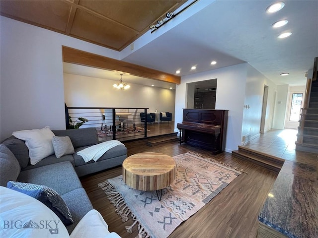 living room featuring a chandelier and wood-type flooring