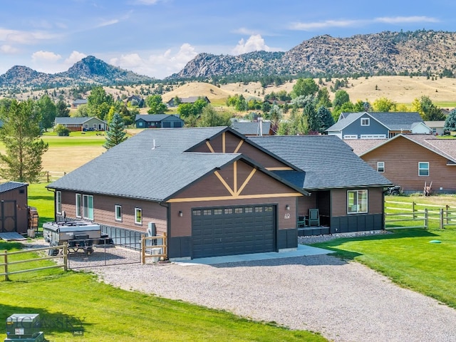 view of front facade featuring a mountain view and a front lawn