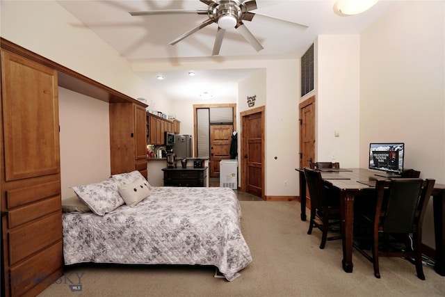 bedroom featuring ceiling fan, light colored carpet, and stainless steel refrigerator