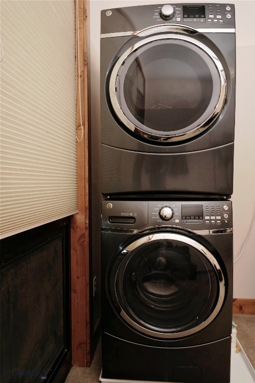 washroom featuring stacked washing maching and dryer