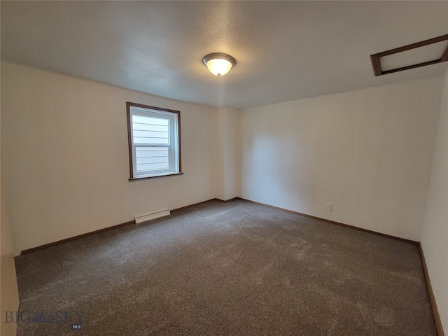 empty room featuring dark carpet and a baseboard radiator