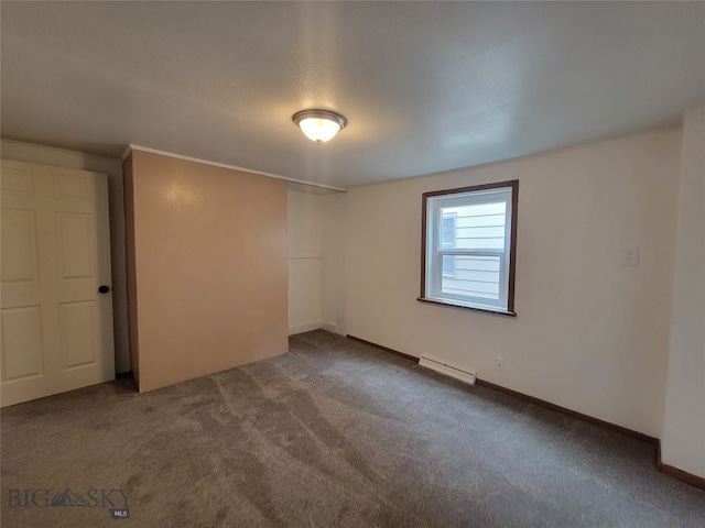 carpeted empty room with baseboard heating