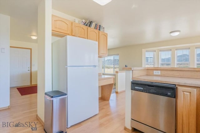 285 Mt Highway 55, Whitehall, MT 59759 - kitchen with stainless steel dishwasher, light brown cabinetry, light wood-type flooring, and freestanding refrigerator