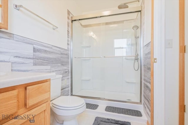 285 Mt Highway 55, Whitehall, MT 59759 - bathroom featuring tile walls, vanity, a shower stall, and toilet