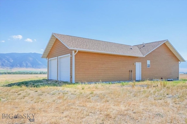 285 Mt Highway 55, Whitehall, MT 59759 - view of home's exterior with roof with shingles, a mountain view, and a garage