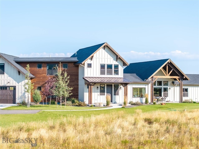 modern inspired farmhouse with a garage and a front lawn