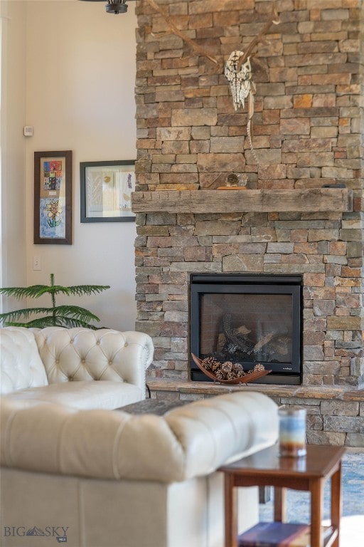 living room with a stone fireplace