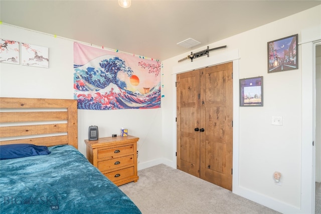 bedroom with light colored carpet and a closet