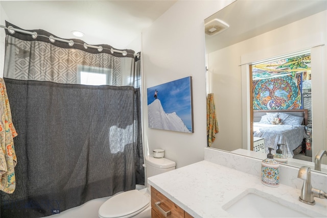 full bathroom featuring shower / bath combination with curtain, vanity, and toilet