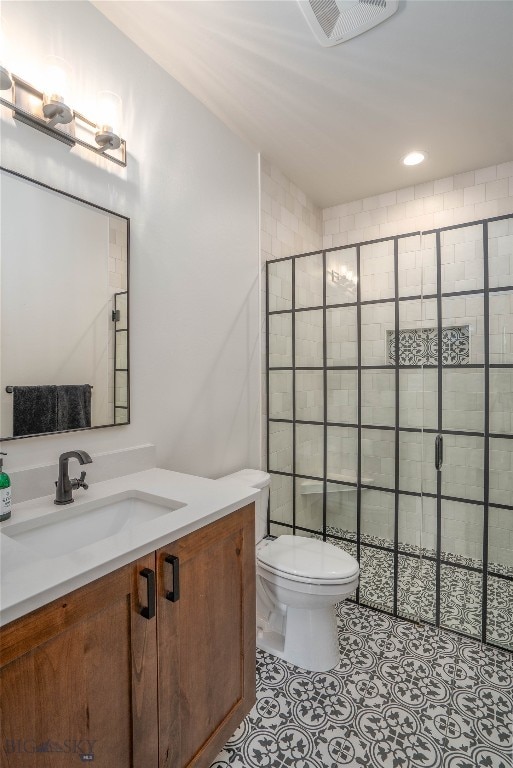 bathroom with walk in shower, vanity, and toilet