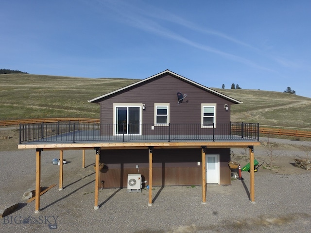 exterior space featuring a deck, ac unit, and a rural view