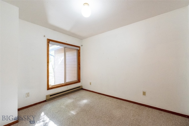 carpeted spare room with a baseboard radiator