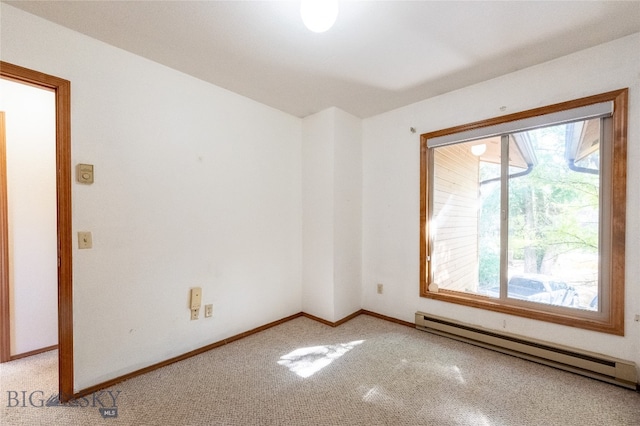 spare room featuring baseboard heating and carpet floors