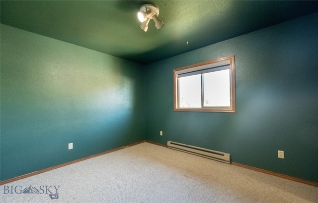 unfurnished room featuring baseboard heating and carpet floors