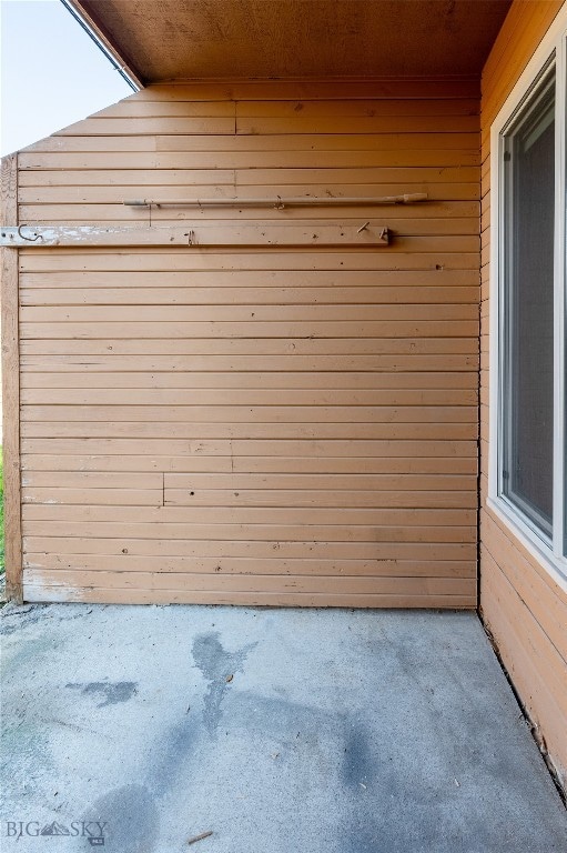 garage with wooden ceiling and wooden walls