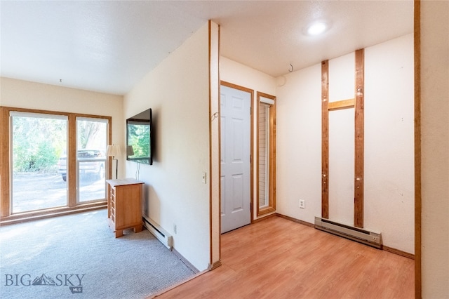 interior space featuring light hardwood / wood-style flooring and a baseboard heating unit