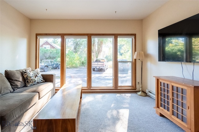 carpeted living room featuring a baseboard heating unit