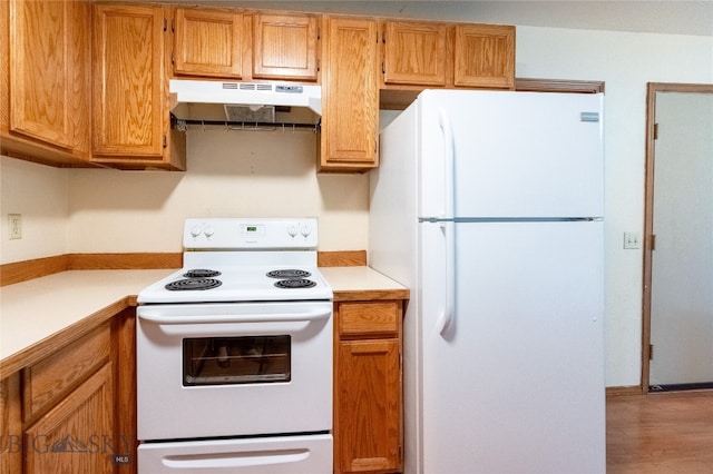 kitchen with wood-type flooring and white appliances