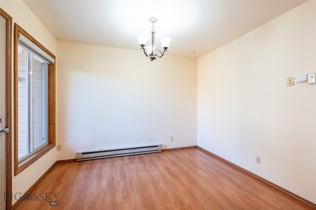 empty room with an inviting chandelier, baseboard heating, light wood-type flooring, and a healthy amount of sunlight