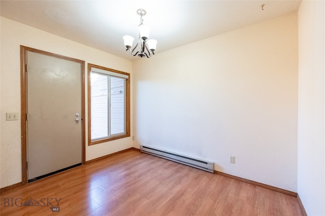 unfurnished room with an inviting chandelier, baseboard heating, and hardwood / wood-style floors