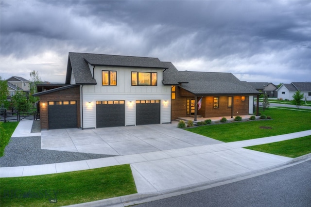 view of front of property with a garage and a front lawn