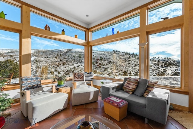 sunroom / solarium with a mountain view and a wealth of natural light