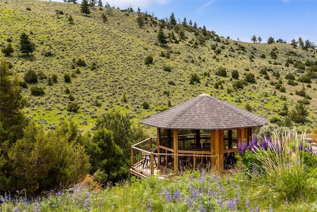 back of property featuring a gazebo