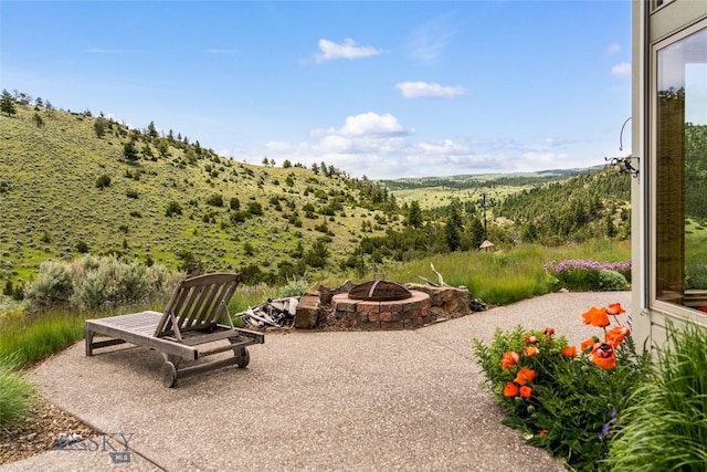 exterior space featuring a patio area and an outdoor fire pit