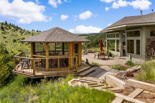 exterior space featuring a gazebo, a deck, and a patio