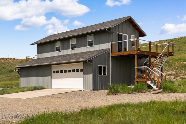 view of front of house featuring a garage and a wooden deck