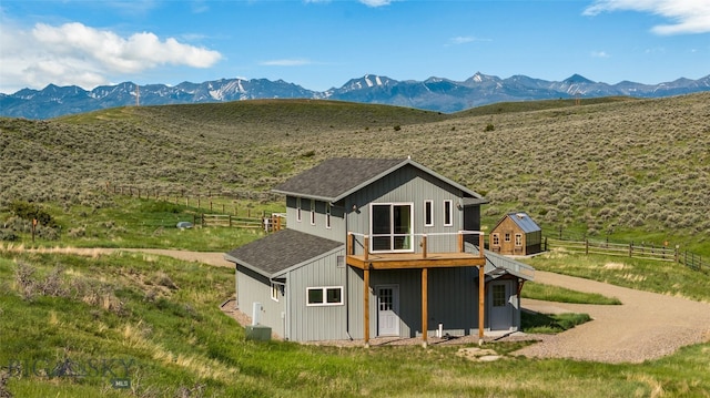 back of house featuring a mountain view, a rural view, and central air condition unit