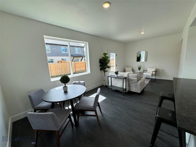 dining area with dark hardwood / wood-style floors