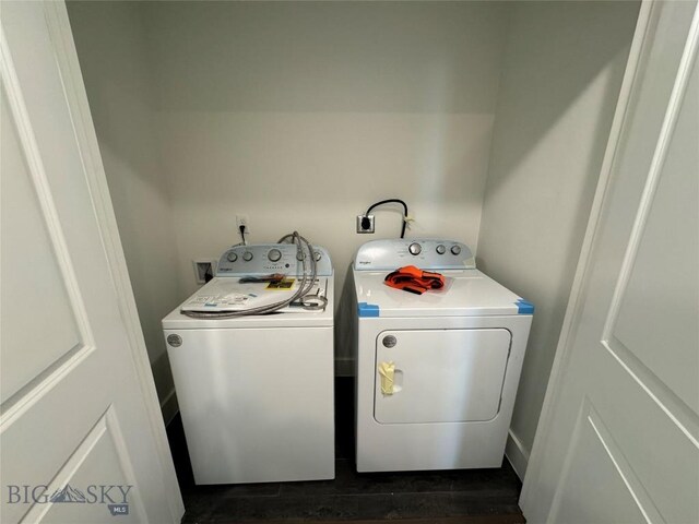 clothes washing area with washing machine and dryer and dark wood-type flooring