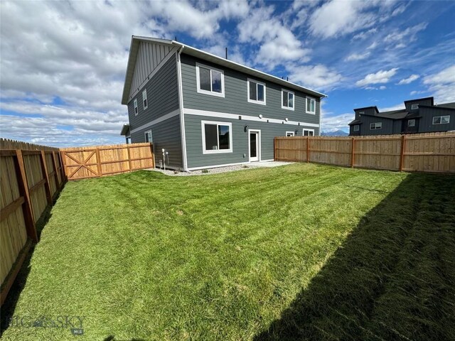 rear view of property with a yard and a patio